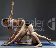 Yoga. Flexible people posing in difficult asanas