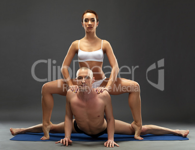 Yoga. Flexible athletes posing at camera
