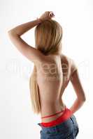 Rear view of slender blonde naked to waist