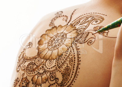 Model's back with beautiful pattern of henna