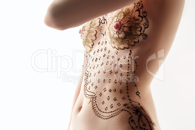 Slim woman with henna patterns on her breasts