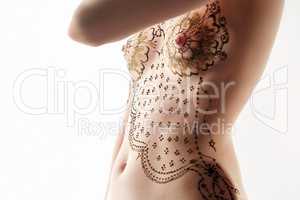 Slim woman with henna patterns on her breasts