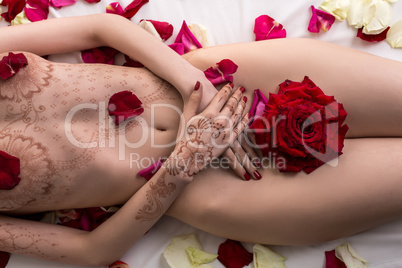 Top view of nude female body with mehendi pattern