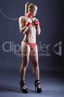 BDSM. Sexy girl posing in handcuffs and on leash