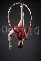 Flexible young girl with hoop posing head down