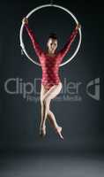 Young beautiful gymnast performs with hoop