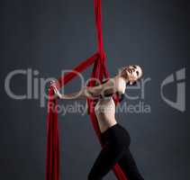 Graceful girl performs dance with hanging ribbons