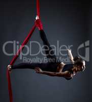 Studio shot of graceful female acrobat posing