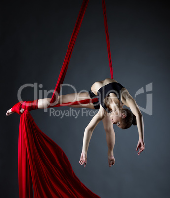 Graceful acrobat posing while doing trick