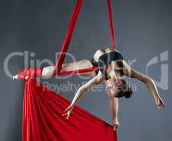 Elegant female dance posing on aerial silks