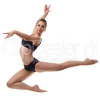 Beautiful female dancer posing in graceful jump