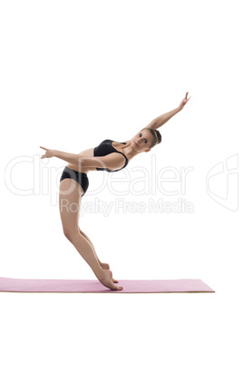 Cute girl posing in difficult equilibrium position