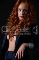 Studio photo of beautiful red-haired model posing
