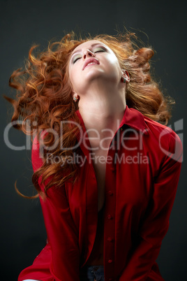 Redhead model posing waving her beautiful hair