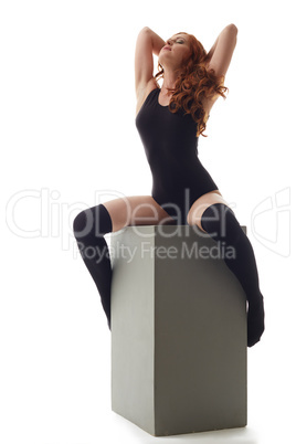 Exciting red-haired model posing in underclothes