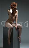 Studio photo. Redhead model posing nude