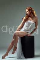 Graceful red-haired model posing in erotic outfit