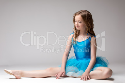Beautiful little ballerina posing doing stretching