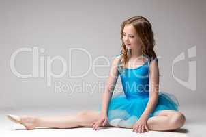 Beautiful little ballerina posing doing stretching