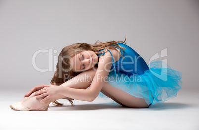 Pretty little dancer posing with eyes closed