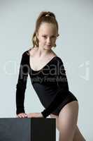 Studio photo of adorable little gymnast posing