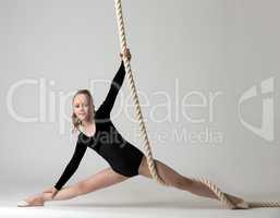 Photo of nice young gymnast training on rope