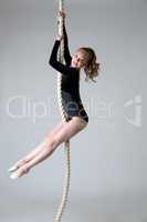 Charming little power gymnast climbs on rope
