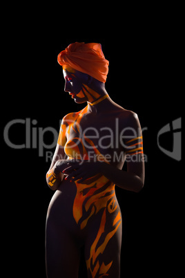 Naked woman posing with body art and turban