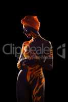 Naked woman posing with body art and turban