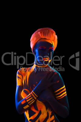 Woman in turban posing under neon light