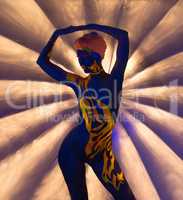 Graceful nude woman posing with glowing patterns