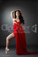 Pretty nude ballerina dancing with red cloth