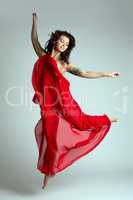 Graceful female dancer posing in jump