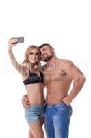 Cute couple athletes doing selfie on mobile phone