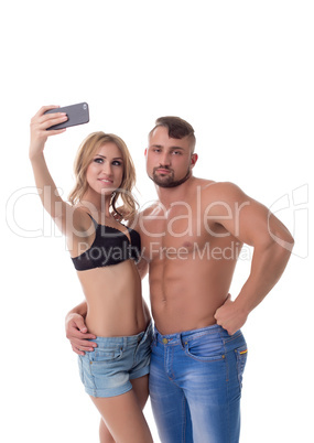 Blonde doing selfie and her boyfriend bored