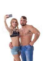 Blonde doing selfie and her boyfriend bored