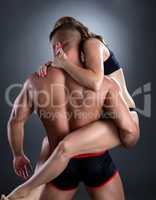 Bodybuilder holds his seductive girlfriend