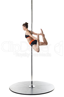 Pretty gymnast warming up on pylon. Studio photo