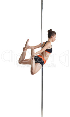 Athletic young girl exercising on pylon