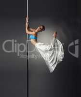 Image of beautiful female dancer posing on pylon