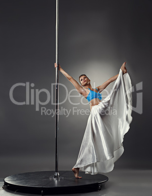 Pole dance. Artistic dancer doing vertical split