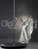 Pole dance. Artistic dancer doing vertical split