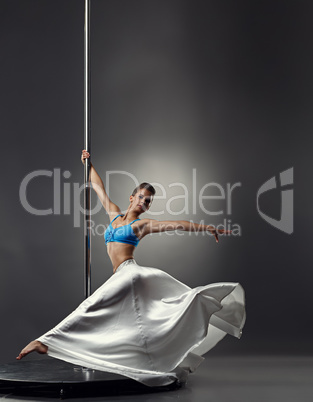 Image of pretty graceful girl dancing on pole