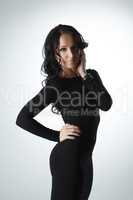 Beautiful brunette posing in tight black dress