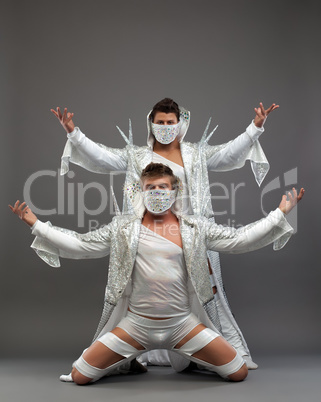 Sexy male dancers in bright costumes and masks