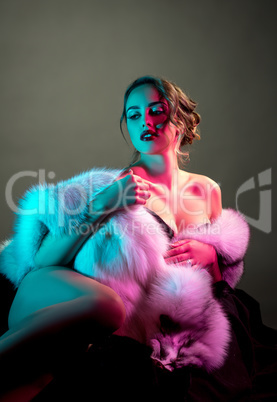 Erotica. Sensual nude model in luxurious fur coat