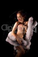 Gorgeous nude model posing with rich fur