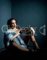 Studio photo of naked girl with expensive fur coat