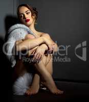 Sexual naked woman posing in chic fur coat