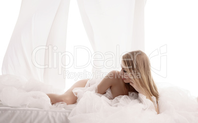 Erotica. Studio photo of pretty woman in bed